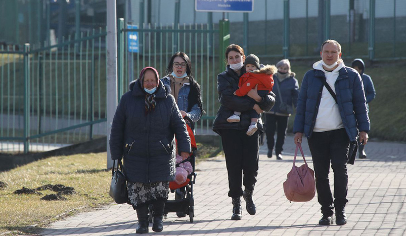 People walk at the border crossing between Poland and Ukraine